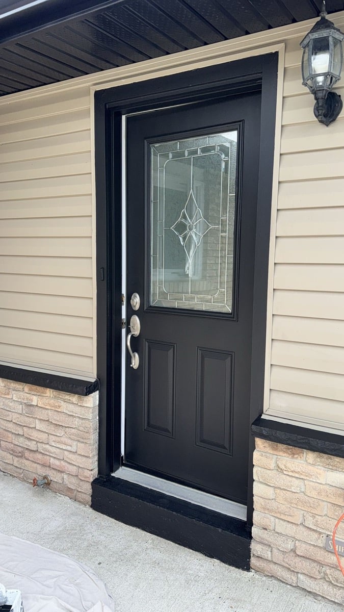 Black entry door with decorative glass installed by Fix N Clean in Toronto