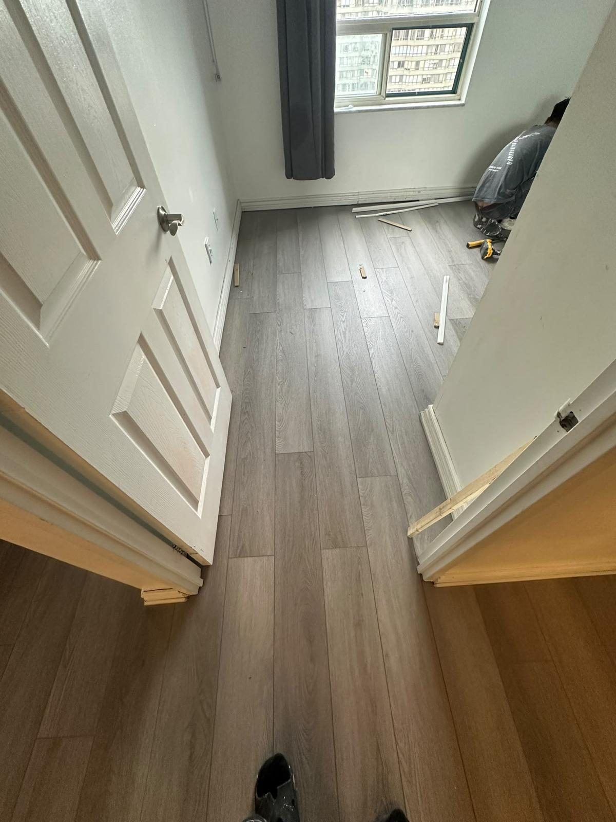 Vinyl plank flooring running through a condo hallway into the bedrooms, Toronto flooring installation